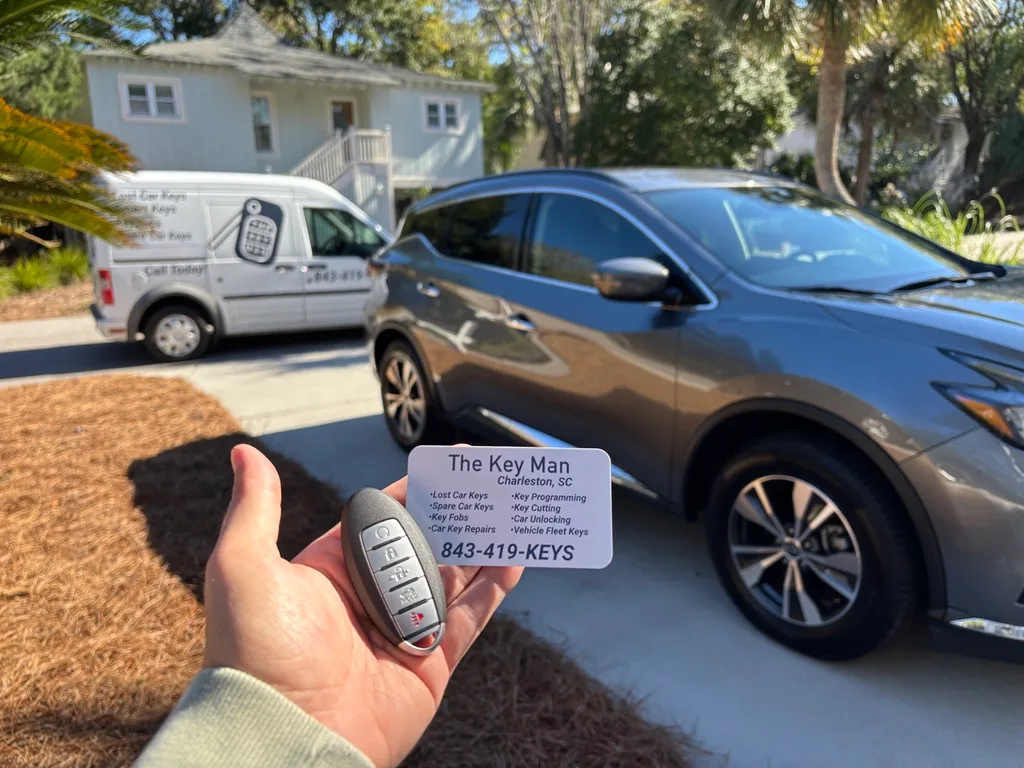 Mobile locksmith working beside a vehicle
